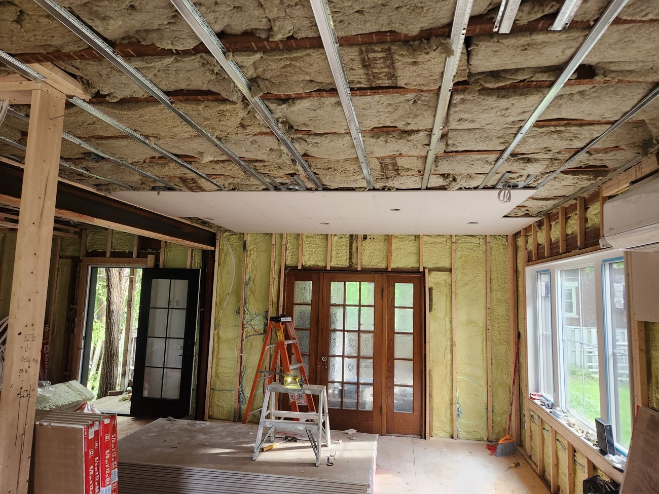 Main-floor renovation with strapped insulated ceiling, new drywall ceiling section, and French doors